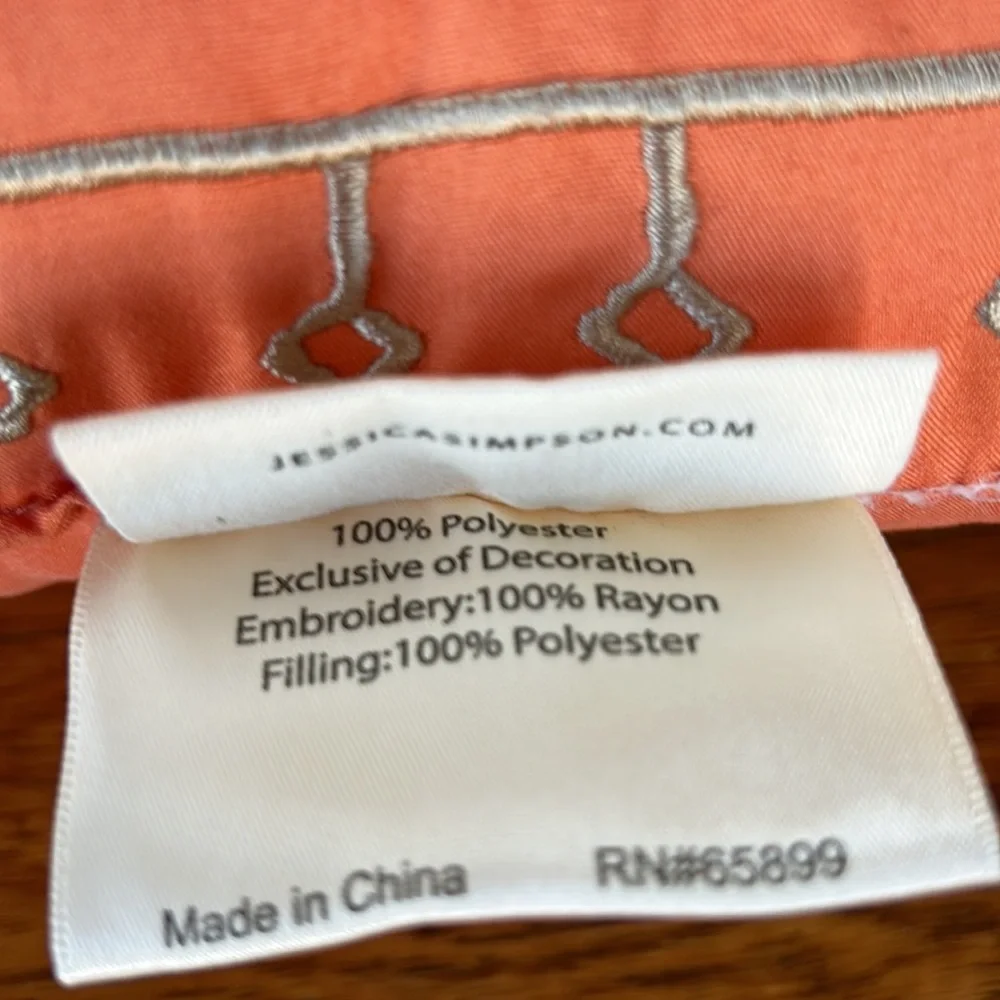 Jessica Simpson accent pillow.  Orange w/tan embroidery on one side.  12”x16.5”